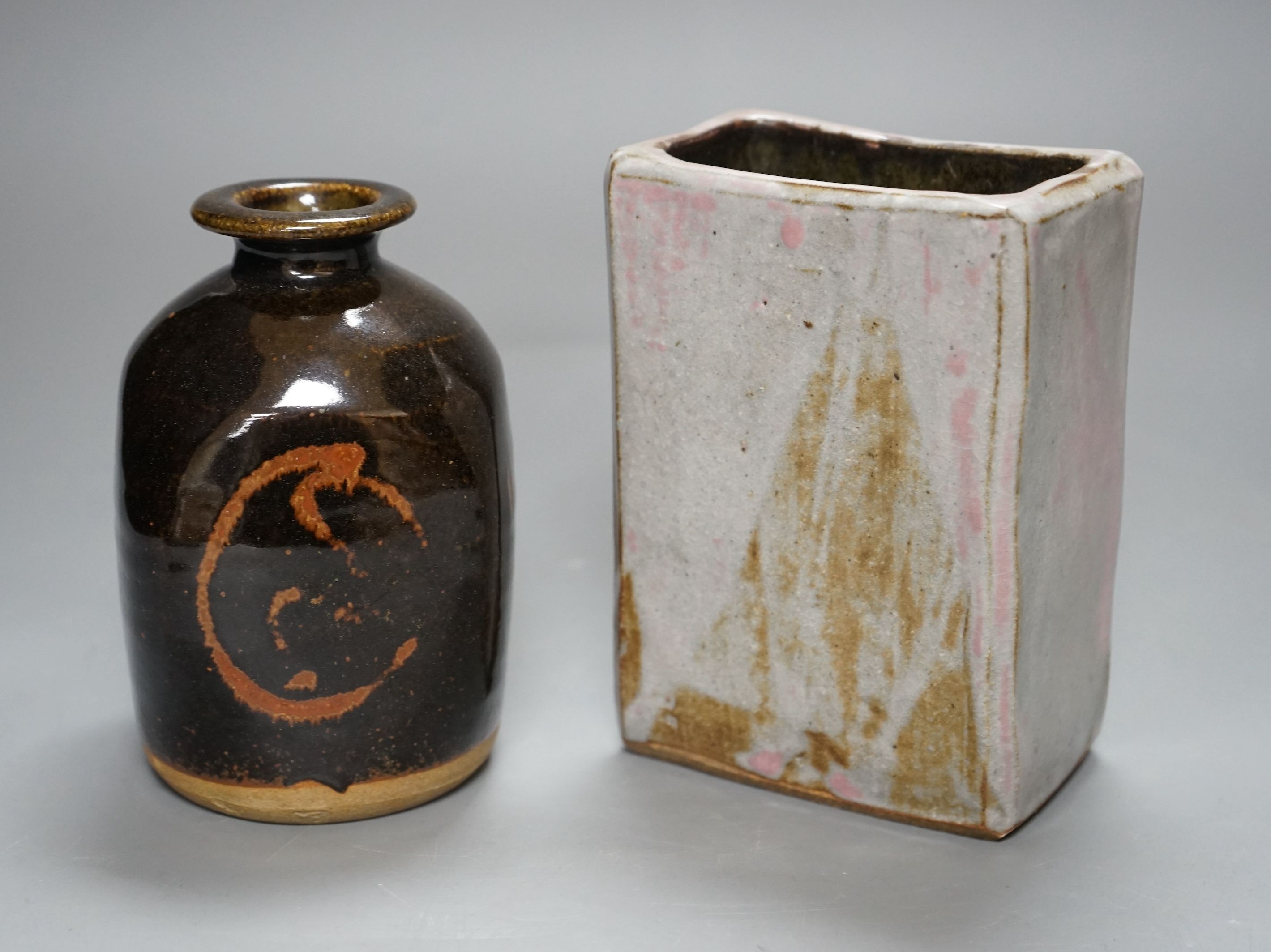 British Studio Pottery; a tenmoku glazed bottle vase, with impressed mark, together with an abstract rectangular blue glaze vase with brown and pink undertones, unmarked, 15cm tall, (2)